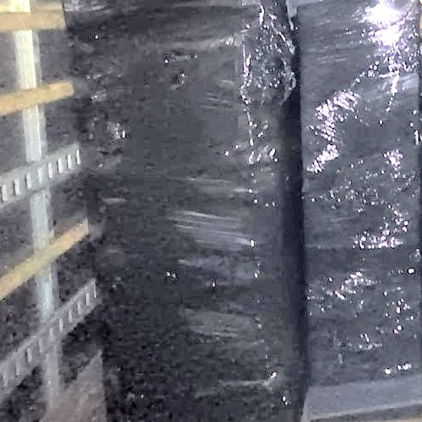 Shrink-wrapped furniture stood tight in a row inside the truck, next to the wall rail